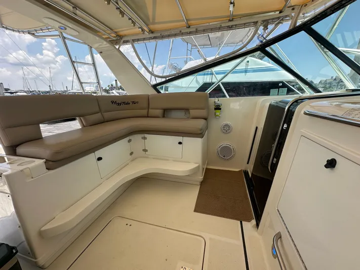 Hoggtide Two Yacht Photos Pics 1998 Tiara Yachts 4100 Open interior with beige seating and helm station.