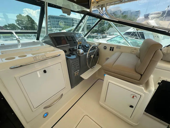 Hoggtide Two Yacht Photos Pics 1998 Tiara Yachts 4100 Open helm station with modern controls and comfortable seating.