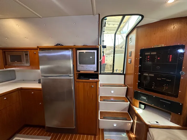 Hoggtide Two Yacht Photos Pics 1998 Tiara Yachts 4100 Open interior with kitchen, stairs, and control panel.