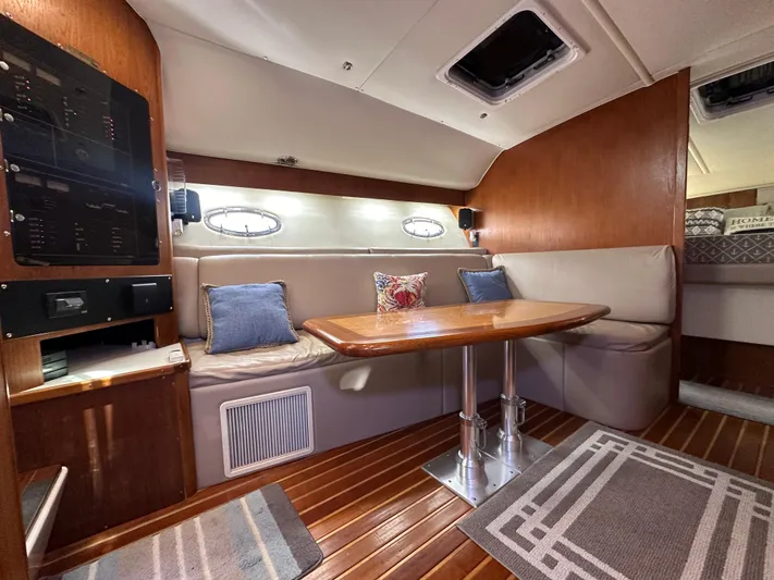 Hoggtide Two Yacht Photos Pics 1998 Tiara Yachts 4100 Open interior with dining area and wooden finishes.