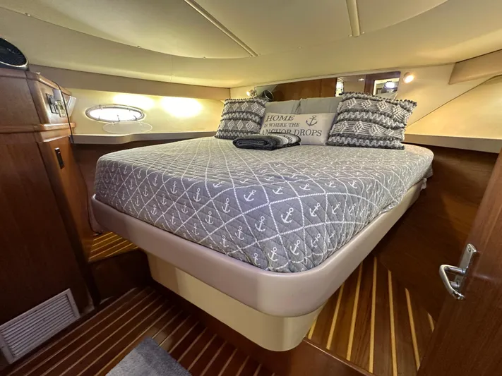 Hoggtide Two Yacht Photos Pics 1998 Tiara Yachts 4100 Open cabin with cozy bed and nautical decor.