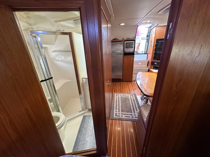 Hoggtide Two Yacht Photos Pics 1998 Tiara Yachts 4100 Open interior with bathroom, kitchen, and dining area.