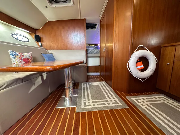 Hoggtide Two Yacht Photos Pics Interior of 1998 Tiara Yachts 4100 Open with wooden flooring and dining area.