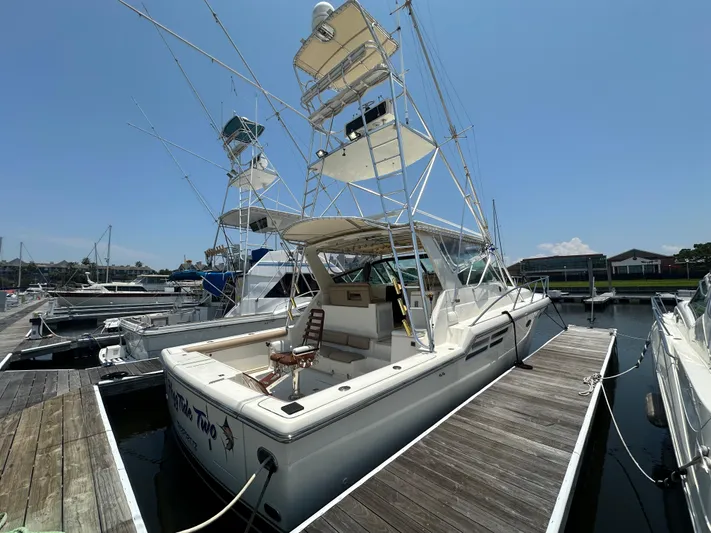 Hoggtide Two Yacht Photos Pics 1998 Tiara Yachts 4100 Open docked at a marina on a sunny day.