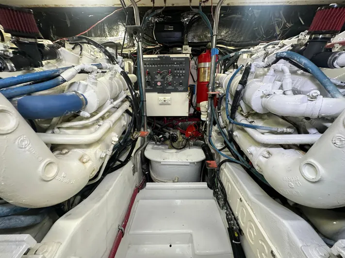 Hoggtide Two Yacht Photos Pics Engine room of 1998 Tiara Yachts 4100 Open, showcasing dual engines and control panel.