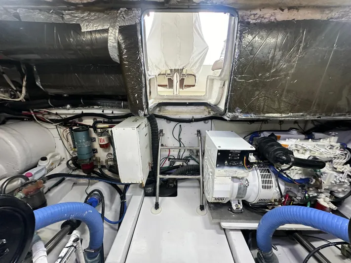 Hoggtide Two Yacht Photos Pics Engine room of 1998 Tiara Yachts 4100 Open, showcasing mechanical components and wiring.