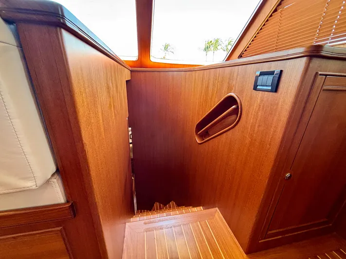 Forever Fun Yacht Photos Pics Interior of 2018 Marlow 53E CB yacht with wooden paneling and stairs.