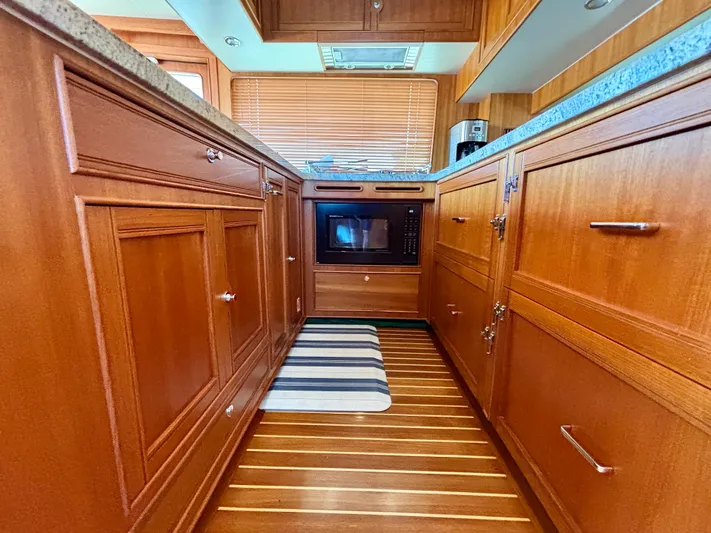 Forever Fun Yacht Photos Pics Luxurious wooden kitchen interior on a 2018 Marlow 53E CB yacht.