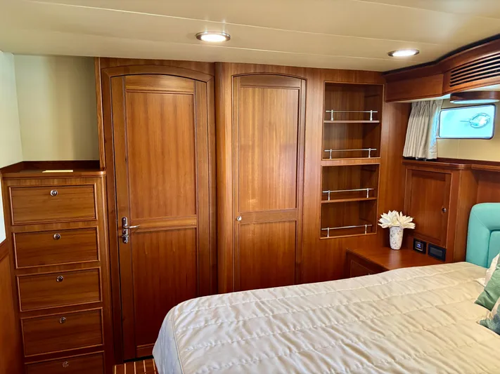Forever Fun Yacht Photos Pics Luxurious wooden interior of 2018 Marlow 53E CB yacht cabin with bed and storage.
