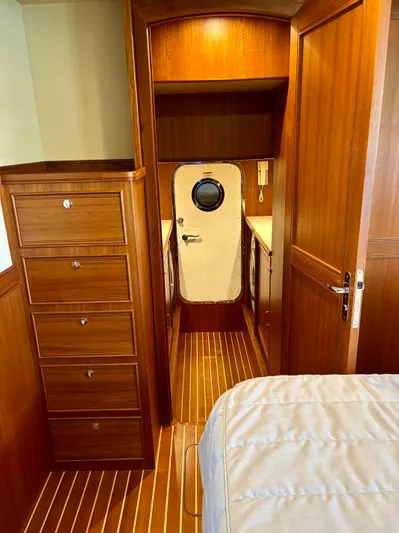 Forever Fun Yacht Photos Pics Luxurious wood interior of 2018 Marlow 53E CB yacht cabin with drawers and porthole.