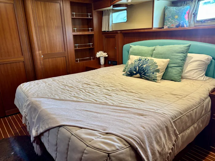 Forever Fun Yacht Photos Pics Luxurious bedroom in 2018 Marlow 53E CB yacht with elegant wood paneling and cozy bedding.