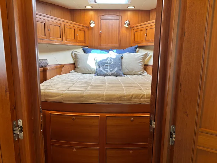 Forever Fun Yacht Photos Pics Luxurious cabin interior of 2018 Marlow 53E CB yacht with wooden finish and cozy bedding.