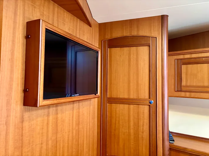 Forever Fun Yacht Photos Pics Interior of 2018 Marlow 53E CB yacht with wood paneling and mounted TV.