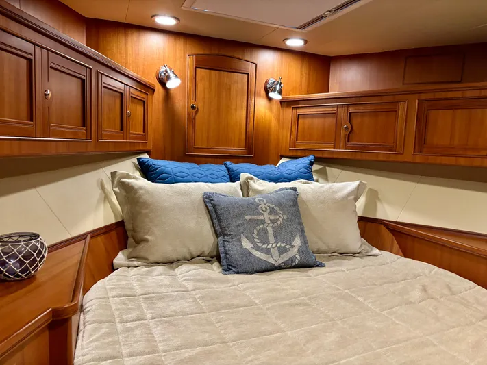 Forever Fun Yacht Photos Pics Luxurious cabin interior of 2018 Marlow 53E CB yacht with cozy bedding and wooden cabinetry.