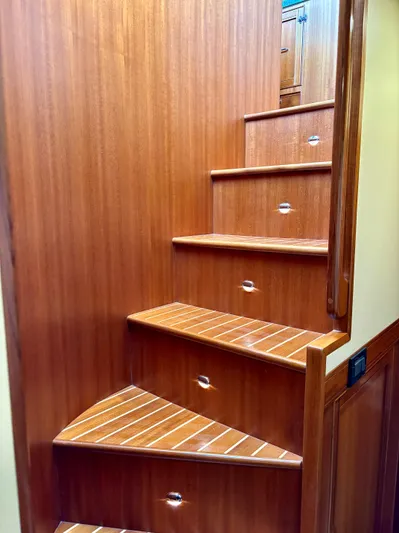 Forever Fun Yacht Photos Pics Wooden staircase inside 2018 Marlow 53E CB yacht, featuring sleek design and polished finish.