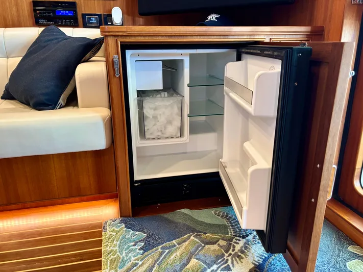 Forever Fun Yacht Photos Pics Open mini fridge with ice compartment in 2018 Marlow 53E CB yacht interior.