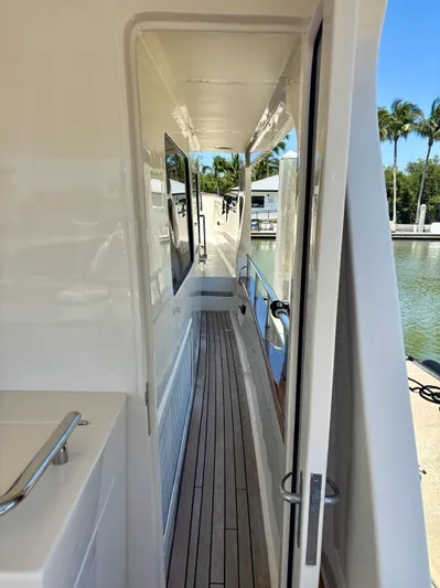 Forever Fun Yacht Photos Pics 2018 Marlow 53E CB yacht side deck with teak flooring and marina view.