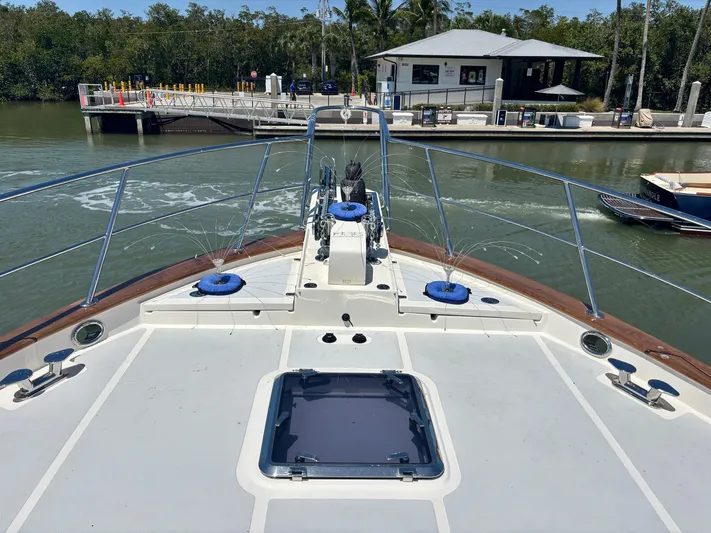 Forever Fun Yacht Photos Pics Bow view of 2018 Marlow 53E CB yacht docked near a marina.