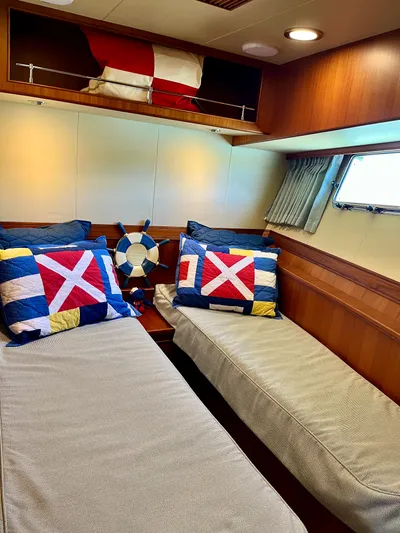 Forever Fun Yacht Photos Pics Cozy twin cabin in 2018 Marlow 53E CB yacht with nautical-themed decor.
