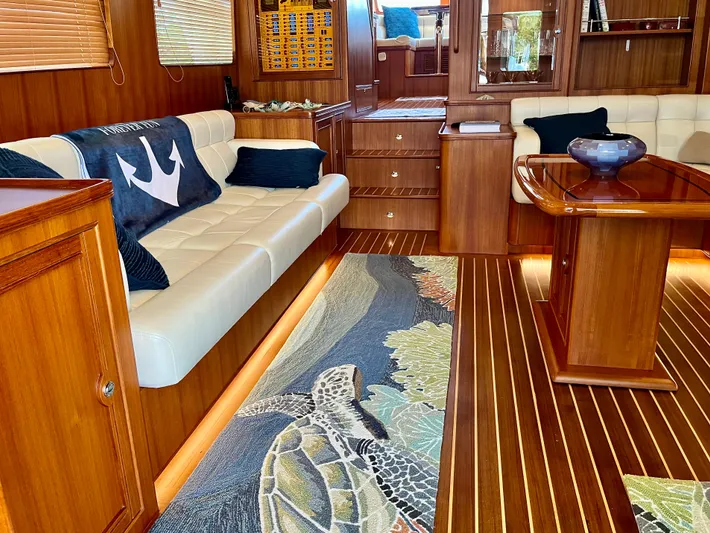 Forever Fun Yacht Photos Pics Luxurious 2018 Marlow 53E CB yacht interior with elegant wood finish and sea turtle rug.
