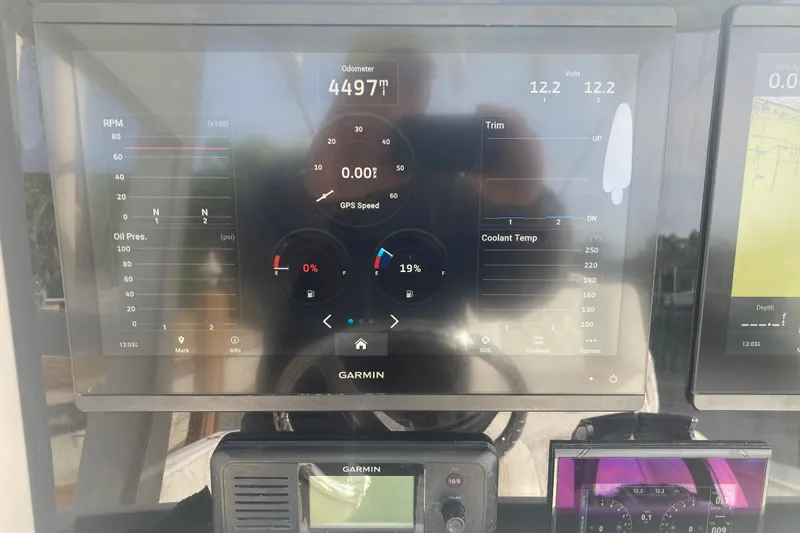 Sandtastic Yacht Photos Pics Garmin display on 2020 Invincible 33 Open Fisherman showing odometer and engine metrics.