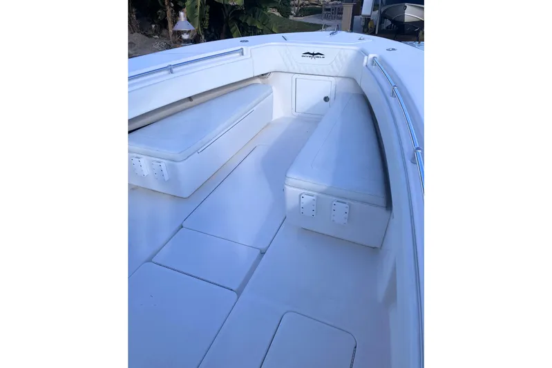 Sandtastic Yacht Photos Pics 2020 Invincible 33 Open Fisherman boat interior with white seating and storage.