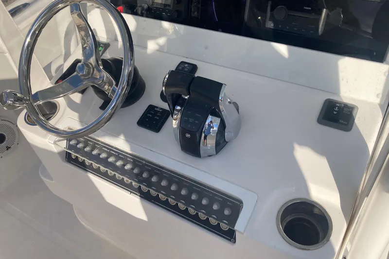 Sandtastic Yacht Photos Pics 2020 Invincible 33 Open Fisherman boat helm with steering wheel and controls.