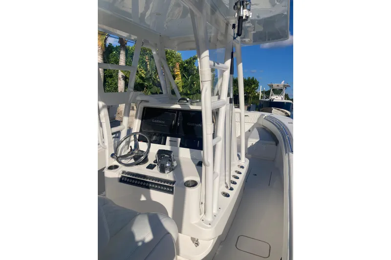 Sandtastic Yacht Photos Pics 2020 Invincible 33 Open Fisherman boat interior with steering wheel and navigation system.
