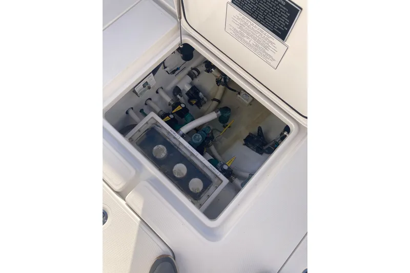 Sandtastic Yacht Photos Pics 2020 Invincible 33 Open Fisherman boat compartment with visible plumbing and equipment.