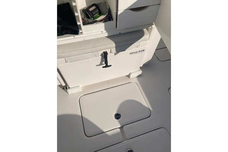 Sandtastic Yacht Photos Pics 2020 Invincible 33 Open Fisherman boat interior with storage compartments and cooler.