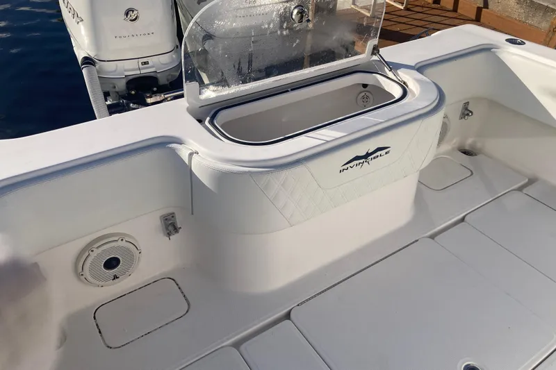 Sandtastic Yacht Photos Pics 2020 Invincible 33 Open Fisherman boat interior with storage compartment and speaker.