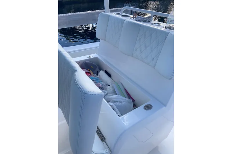 Sandtastic Yacht Photos Pics 2020 Invincible 33 Open Fisherman boat with open storage compartment and cushioned seating.