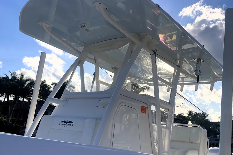 Sandtastic Yacht Photos Pics 2020 Invincible 33 Open Fisherman boat with T-top against a sunny sky.