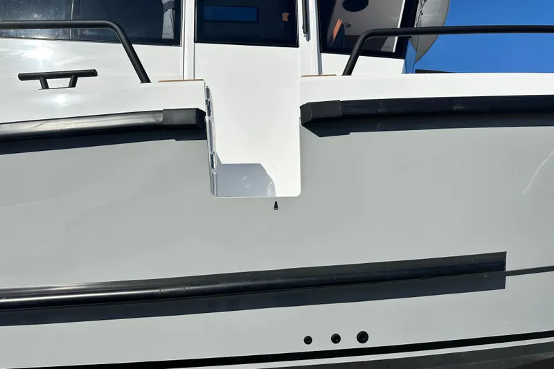  Yacht Photos Pics Close-up of 2025 Sargo 31OB boat exterior with sleek design and black railings.