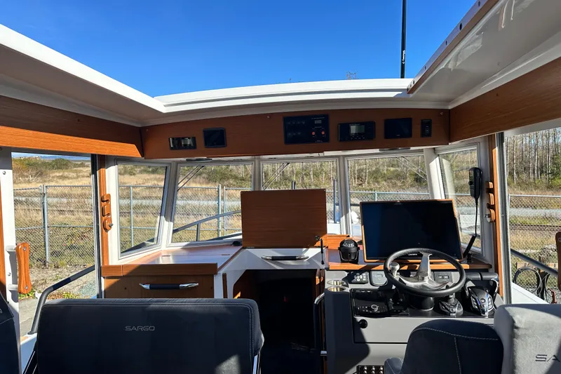  Yacht Photos Pics Interior of 2025 Sargo 31OB boat with modern navigation equipment and steering wheel.