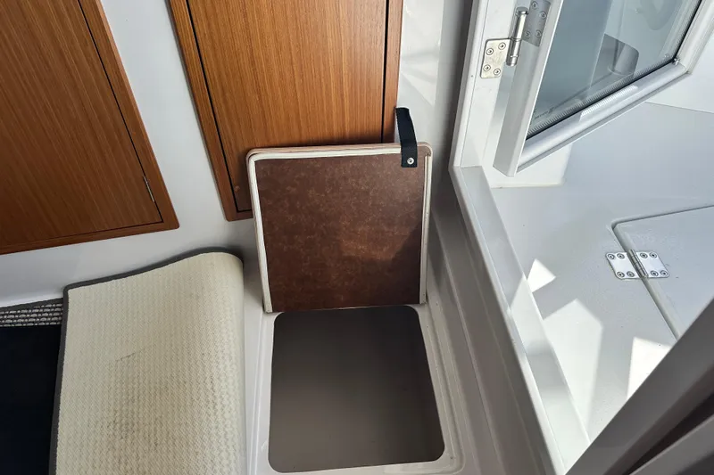  Yacht Photos Pics Interior of 2025 Sargo 31OB boat showing storage compartment and open window.