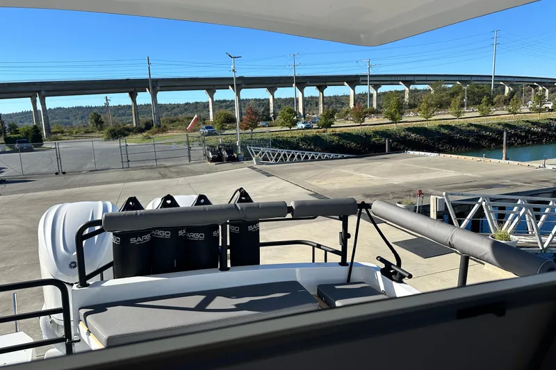  Yacht Photos Pics 2025 Sargo 31OB boat docked near a bridge, sunny day, clear sky.