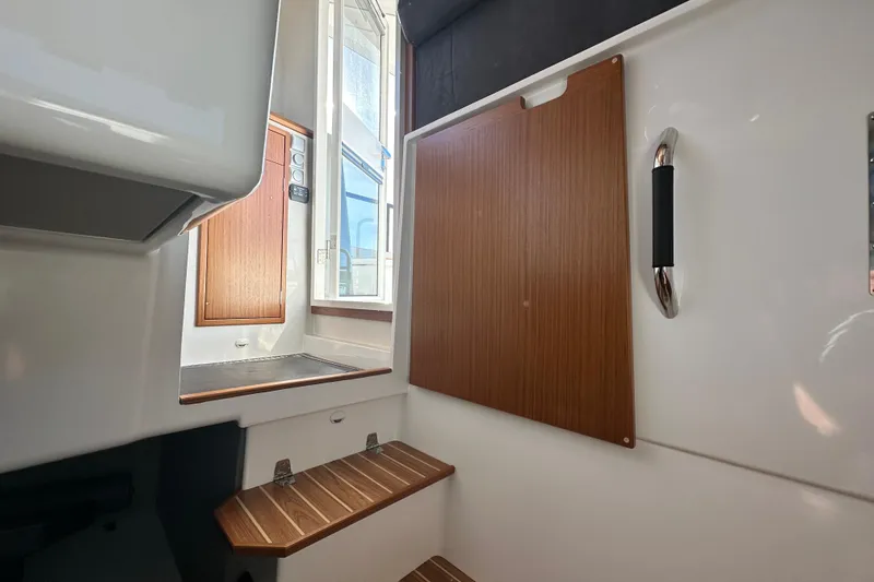  Yacht Photos Pics Interior of 2025 Sargo 31OB boat with wooden accents and steps.