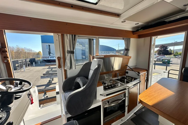  Yacht Photos Pics Interior of 2025 Sargo 31OB boat with modern kitchen and seating area.
