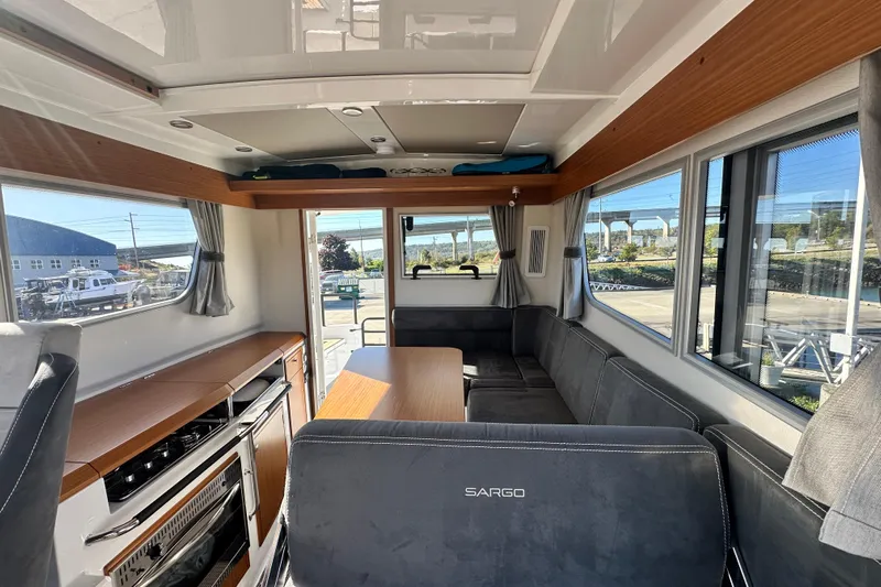  Yacht Photos Pics Interior of 2025 Sargo 31OB boat with modern seating and kitchen area.