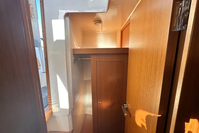  Yacht Photos Pics Interior of 2025 Sargo 31OB boat, featuring wooden cabinetry and compact design.
