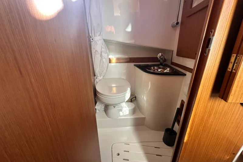  Yacht Photos Pics Compact bathroom in 2025 Sargo 31OB boat with toilet and sink.