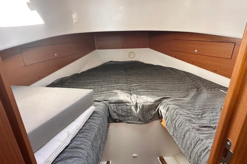  Yacht Photos Pics 2025 Sargo 31OB cabin interior with cozy bedding and wooden accents.