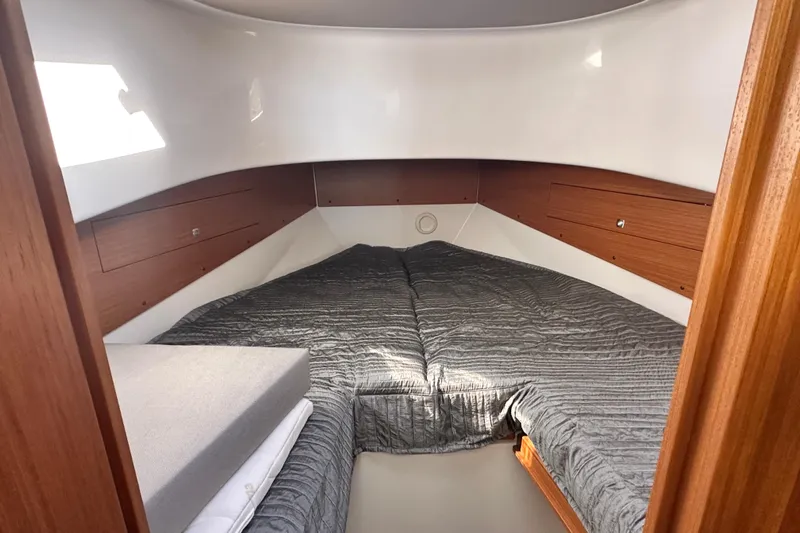  Yacht Photos Pics 2025 Sargo 31OB cabin interior with cozy bed and wooden accents.
