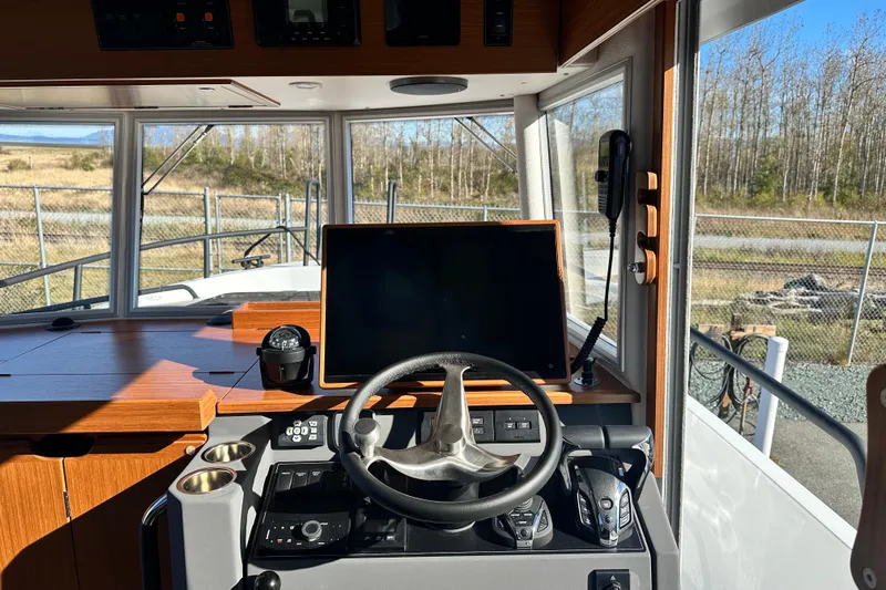  Yacht Photos Pics Interior view of 2025 Sargo 31OB boat cockpit with steering wheel and navigation equipment.