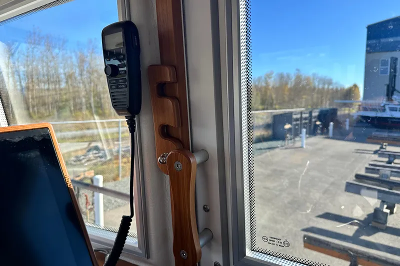  Yacht Photos Pics Interior of 2025 Sargo 31OB boat showing window and mounted radio handset.