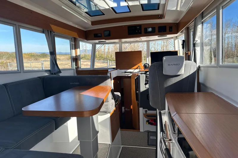  Yacht Photos Pics Interior of 2025 Sargo 31OB boat with modern seating and panoramic windows.