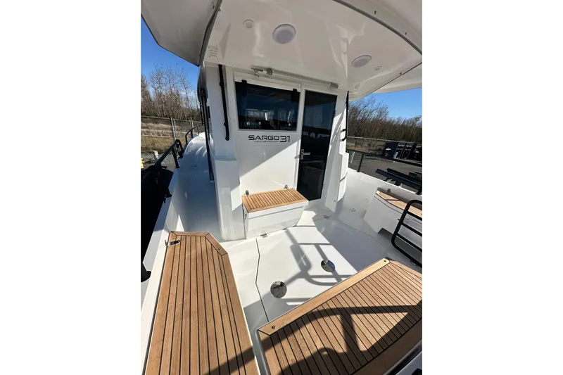  Yacht Photos Pics 2025 Sargo 31OB boat deck with wooden seating and sleek design.