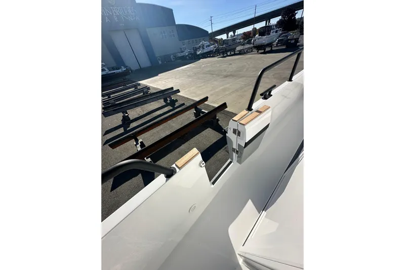  Yacht Photos Pics 2025 Sargo 31OB boat docked at marina with trailers in background.