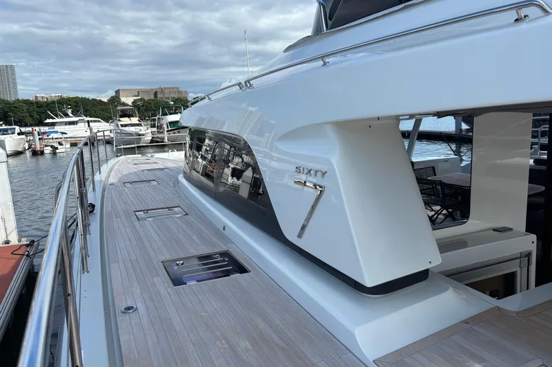 Sixty7 Yacht Photos Pics 2023 Lagoon SIXTY 7 yacht docked at marina, showcasing sleek design and spacious deck.